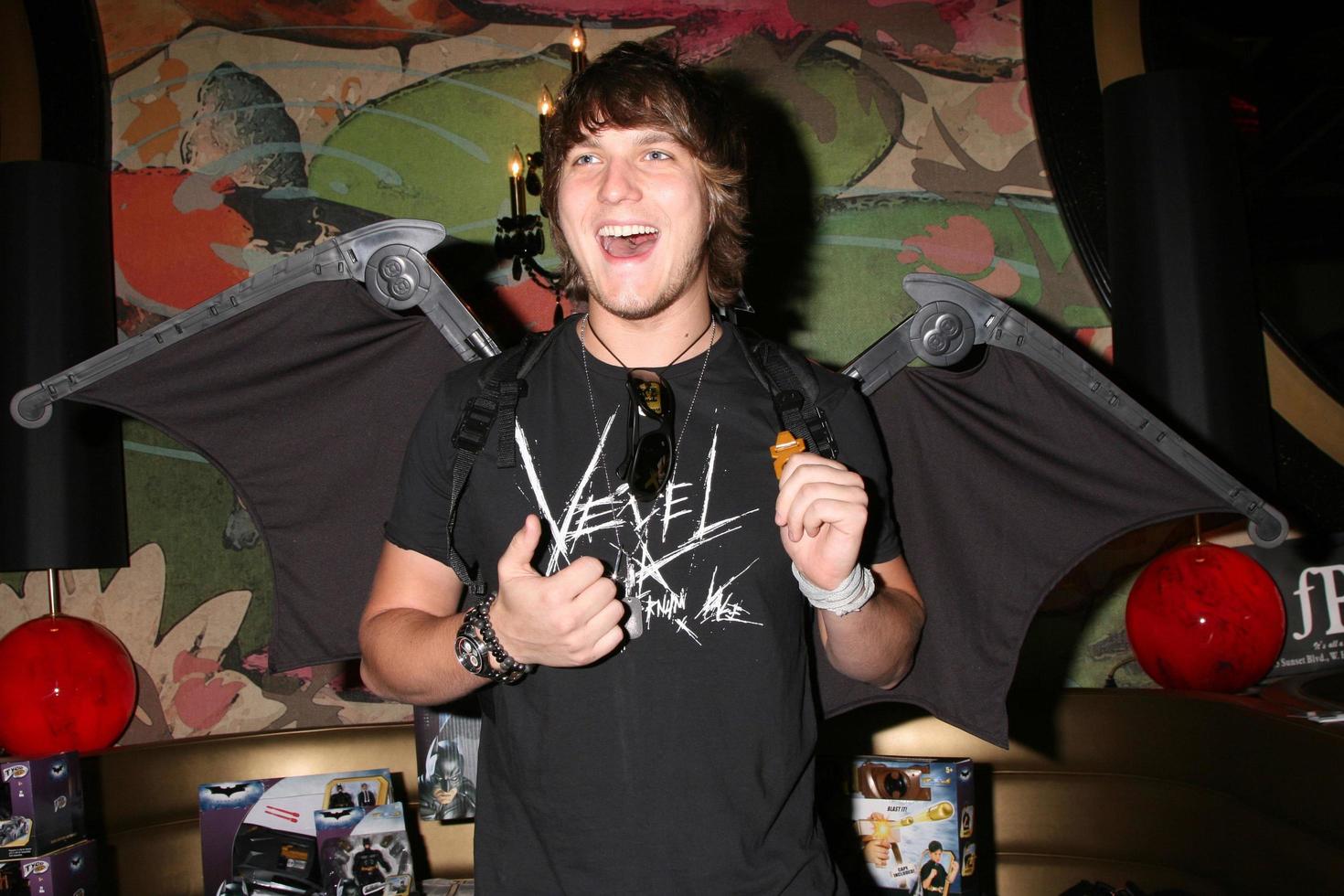 Scott Michael Foster wearing a pair of play Batman wings from Mattel promoting the Dark Knight movieGBK MTV Movie Awards Gifting Suites Crimson  OperaLos Angeles  CAMay 31 20082008 photo
