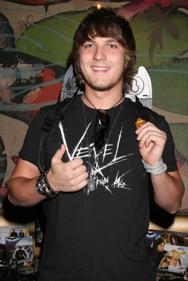 Scott Michael Foster wearing a pair of play Batman wings from Mattel promoting the Dark Knight movieGBK MTV Movie Awards Gifting Suites Crimson  OperaLos Angeles  CAMay 31 20082008 photo