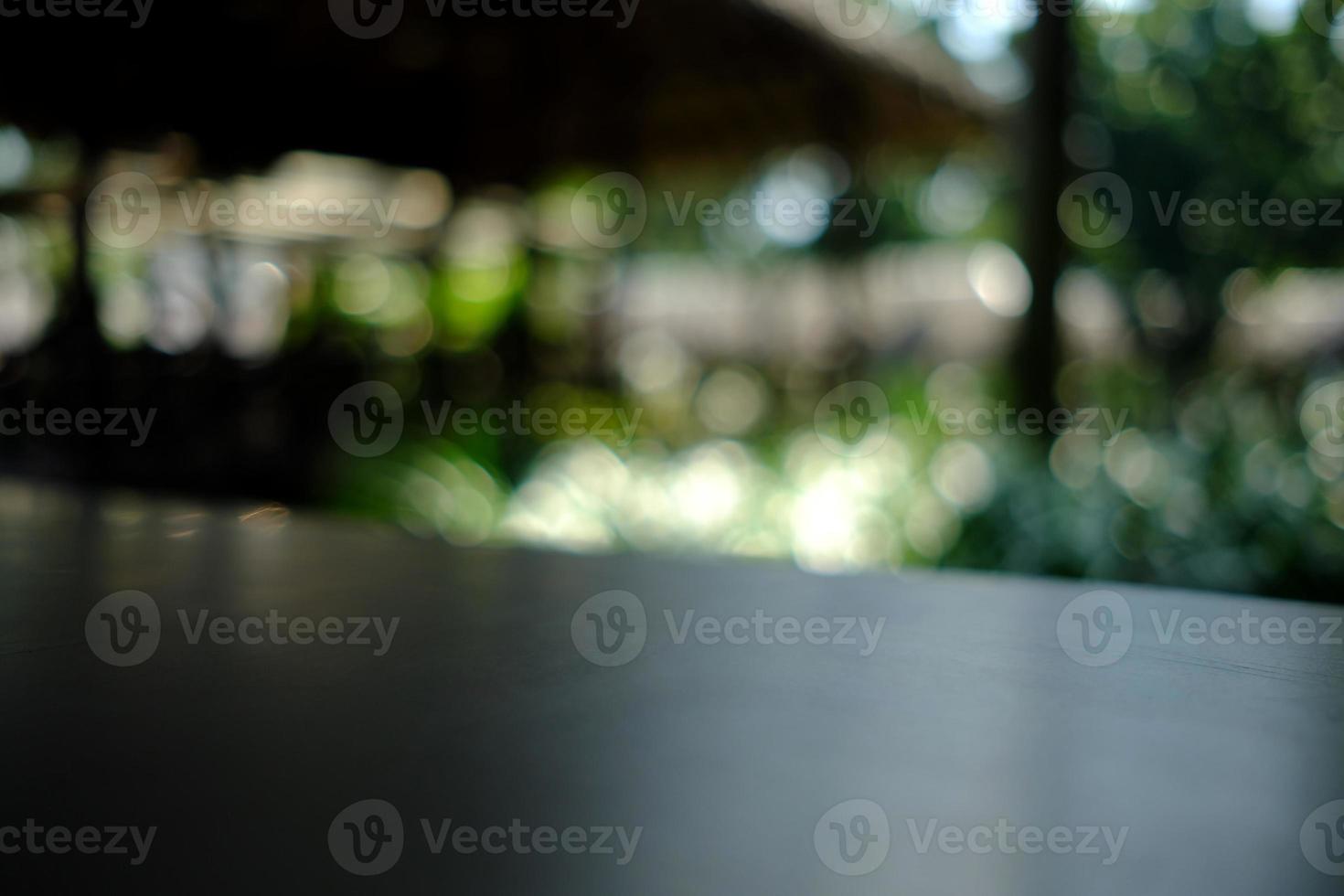 Wooden Table with Nature Bokeh in the Morning, Suitable for Background, Backdrop, and Mock up. photo