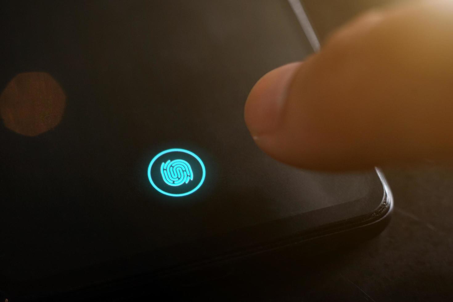 Privacy secure system provides password control digital equipment. Businessman using fingerprint biometric identity scan for access open data composition. Close up of fingerprint icon. photo