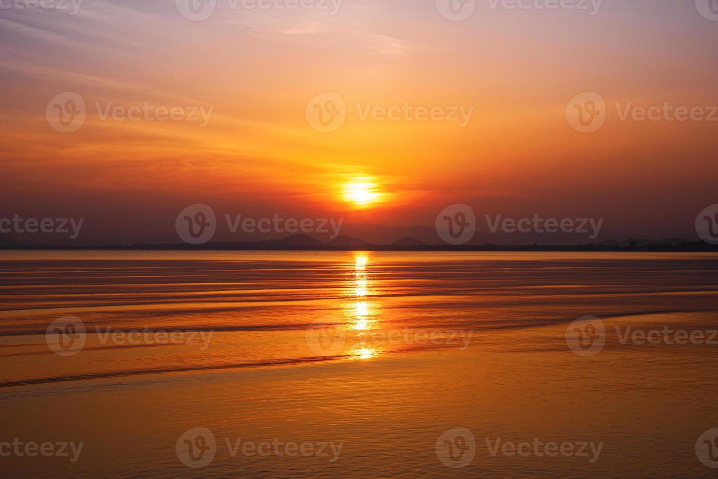 Dramatic sunset over mountain and sea. photo