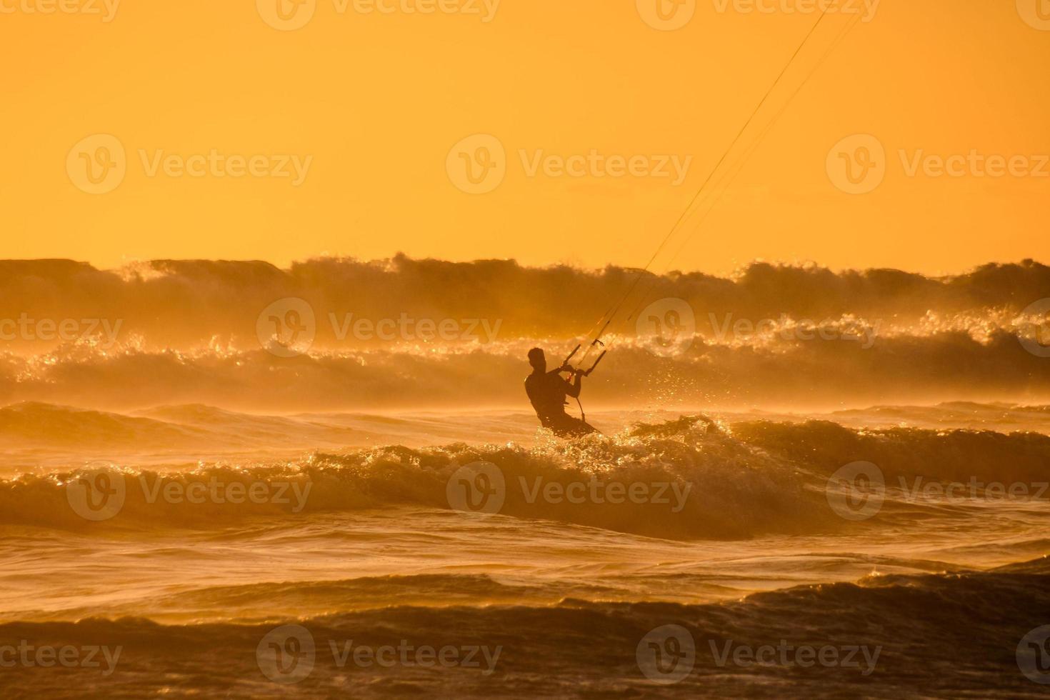 Kitesurfer at sunset photo