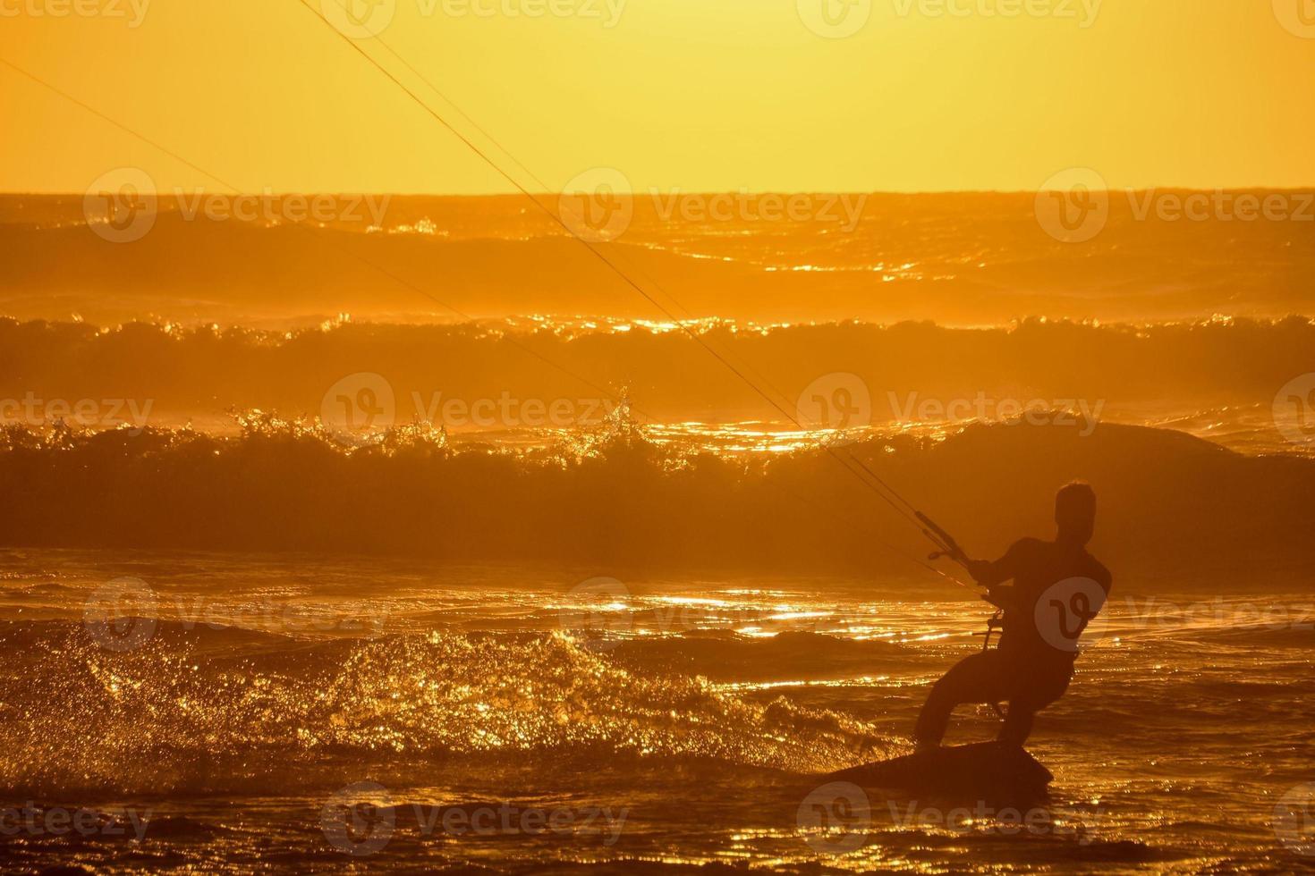 Kitesurfer at sunset photo