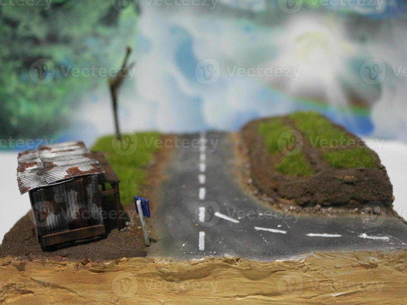 a close up of a diorama of a rice field scene and an old roadside house. miniature diorama photo concept.