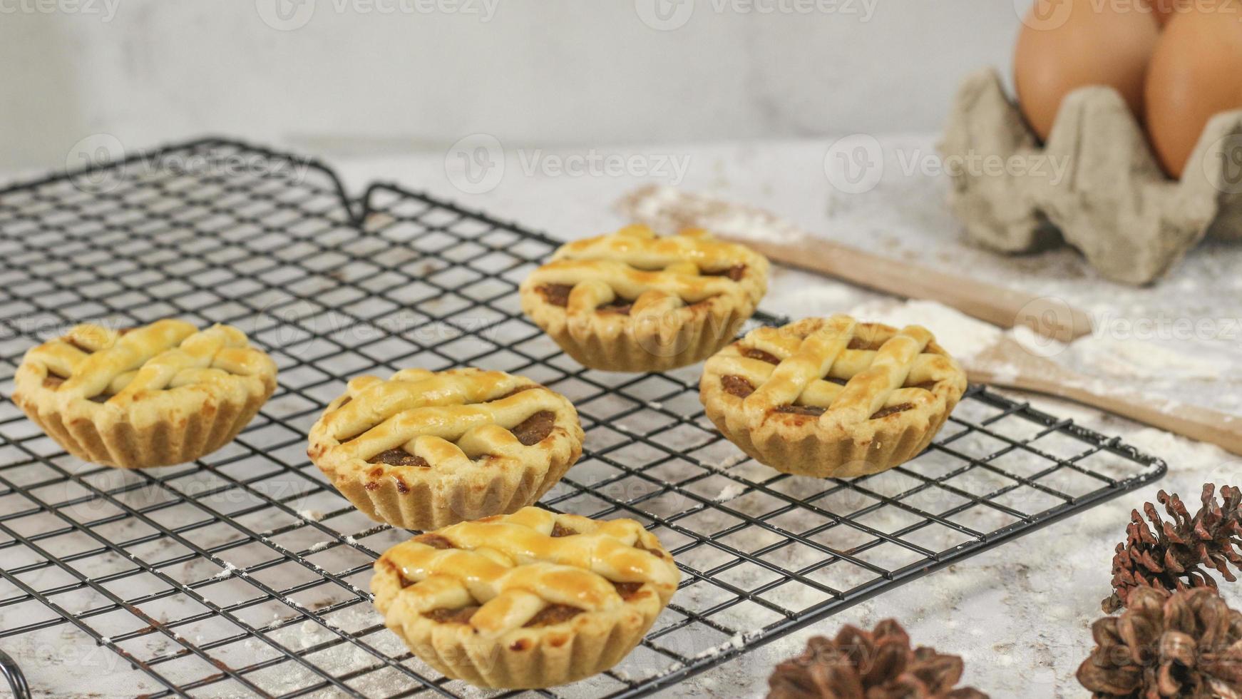 Small apple pie served on a cake rack, tastes sweet and savory. Food concept photo. photo