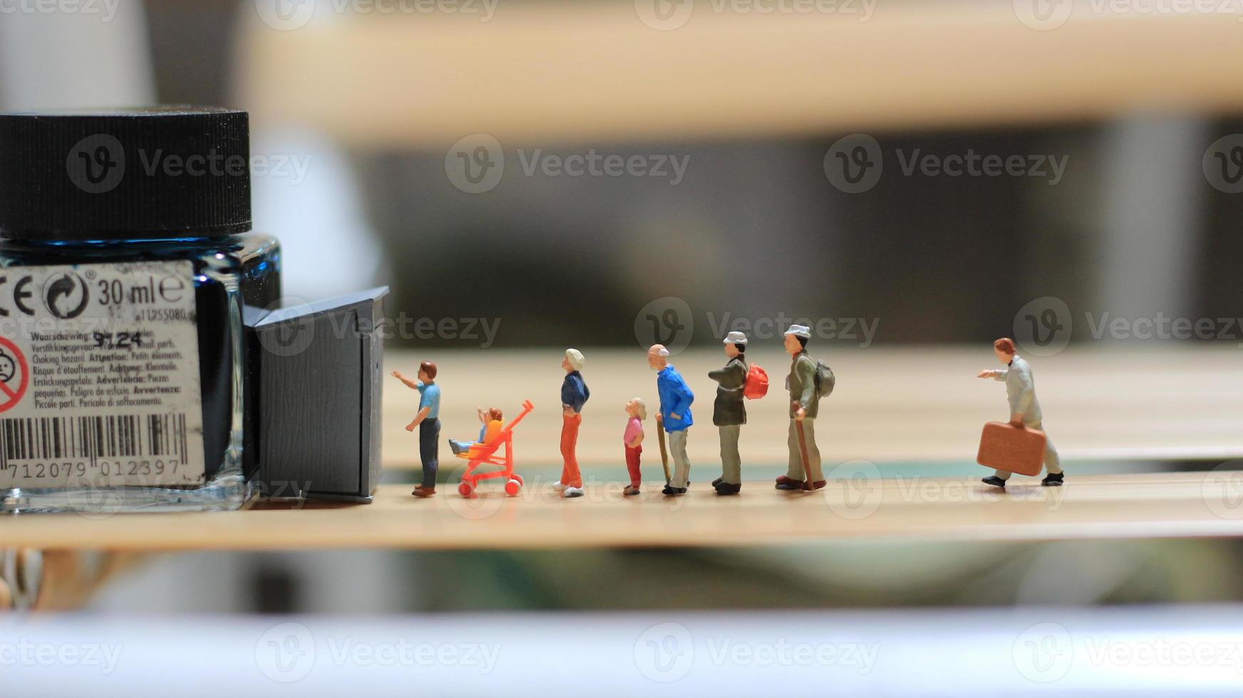 miniature figures of people queuing for public toilets. the concept of social etiquette. photo