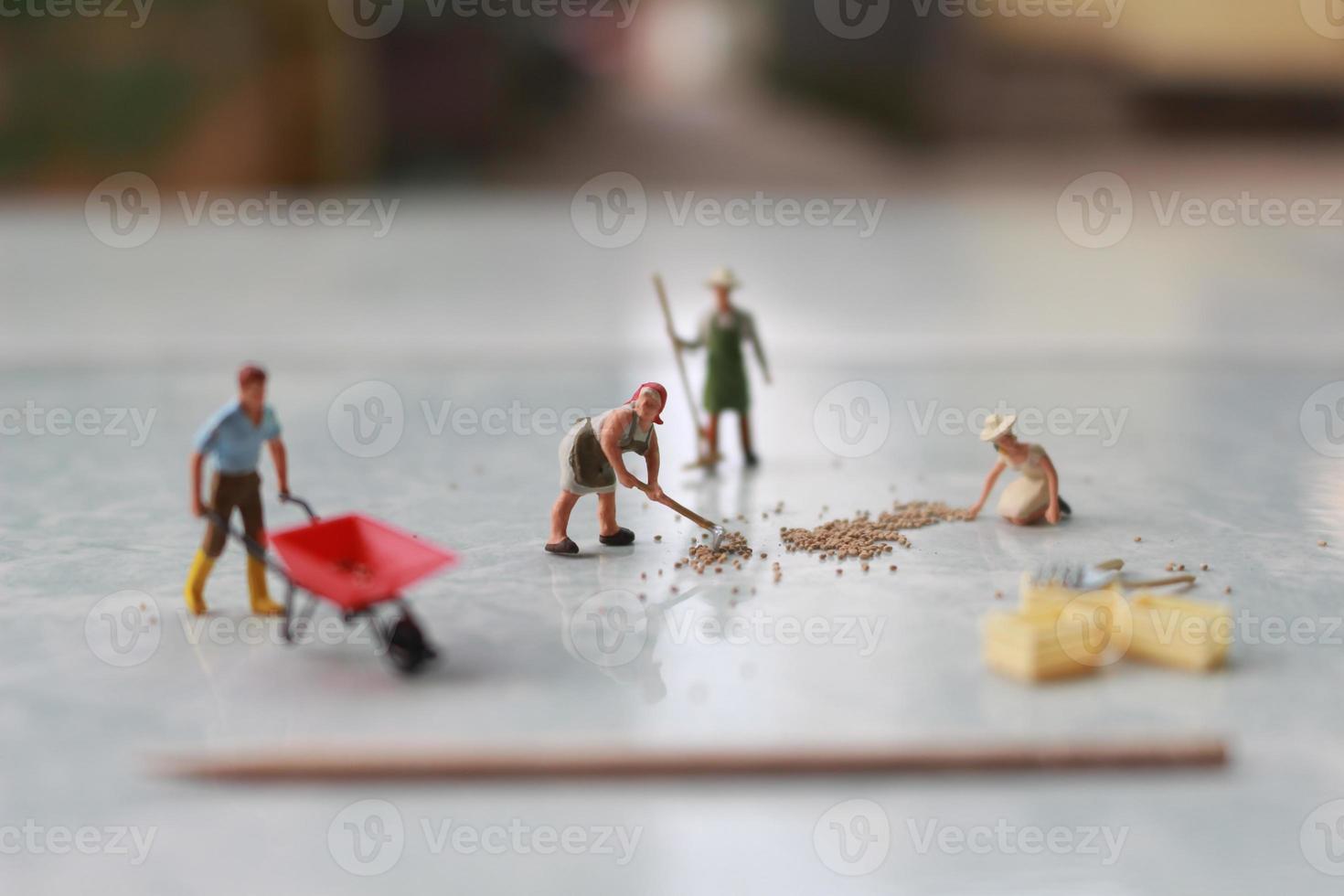 miniature figures of workers working together to move grain. photo