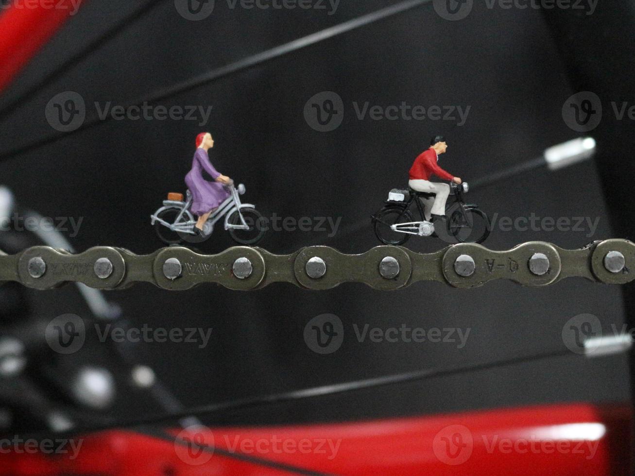 miniature figure of a cyclist riding on a bicycle chain. photo