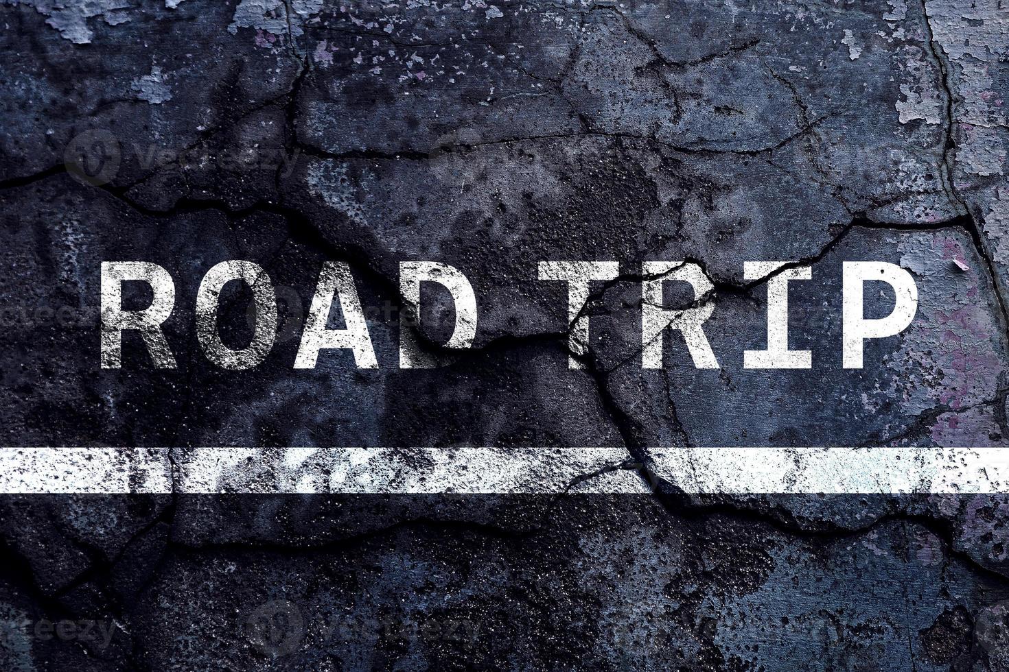 Road trip text written with broken cement wall, road trip word on street. Concept for travel. photo