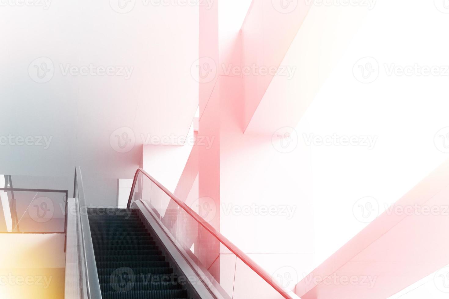 Modern office building and moving escalator stairs, interior design photo