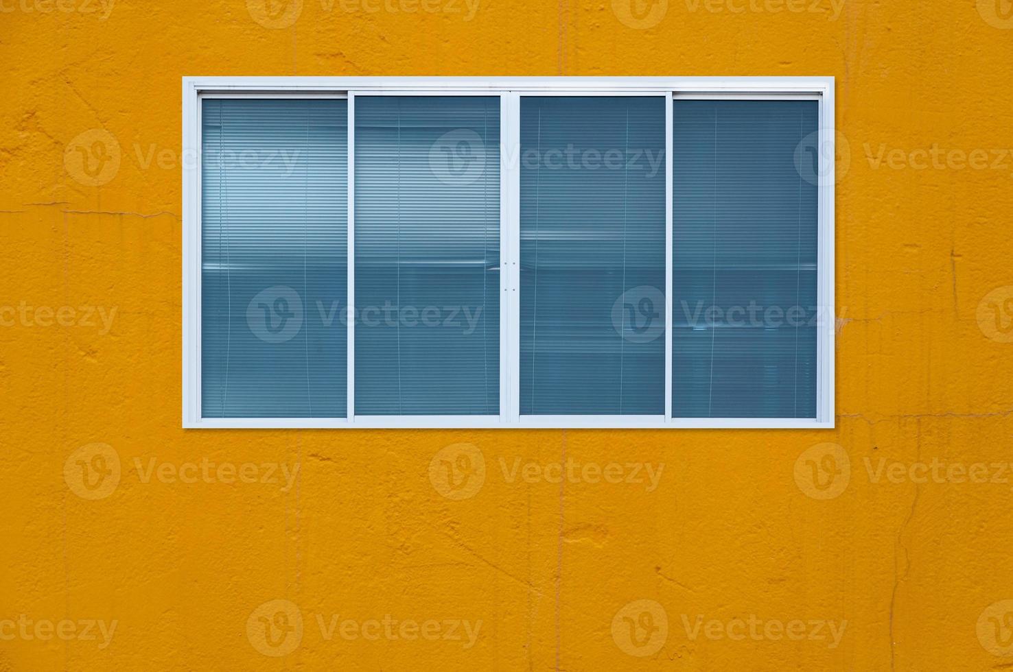 Modern glass window on the yellow wall, blanket window frame photo