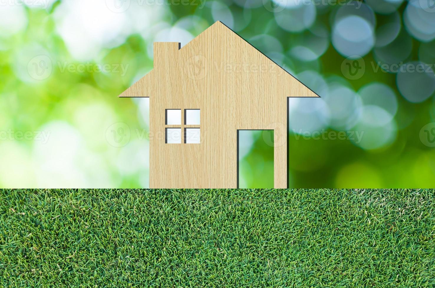 house icon from  wooden on grass texture nature background as symbol of mortgage,Dream house on nature background and space for your text photo