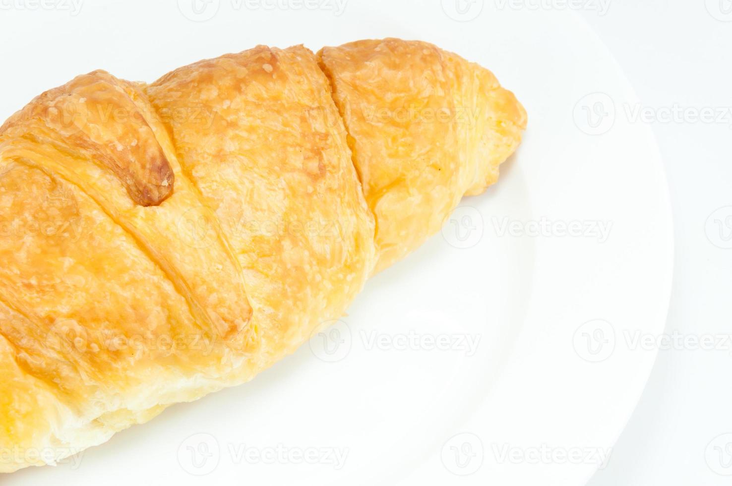 Croissant on white dish on white background photo