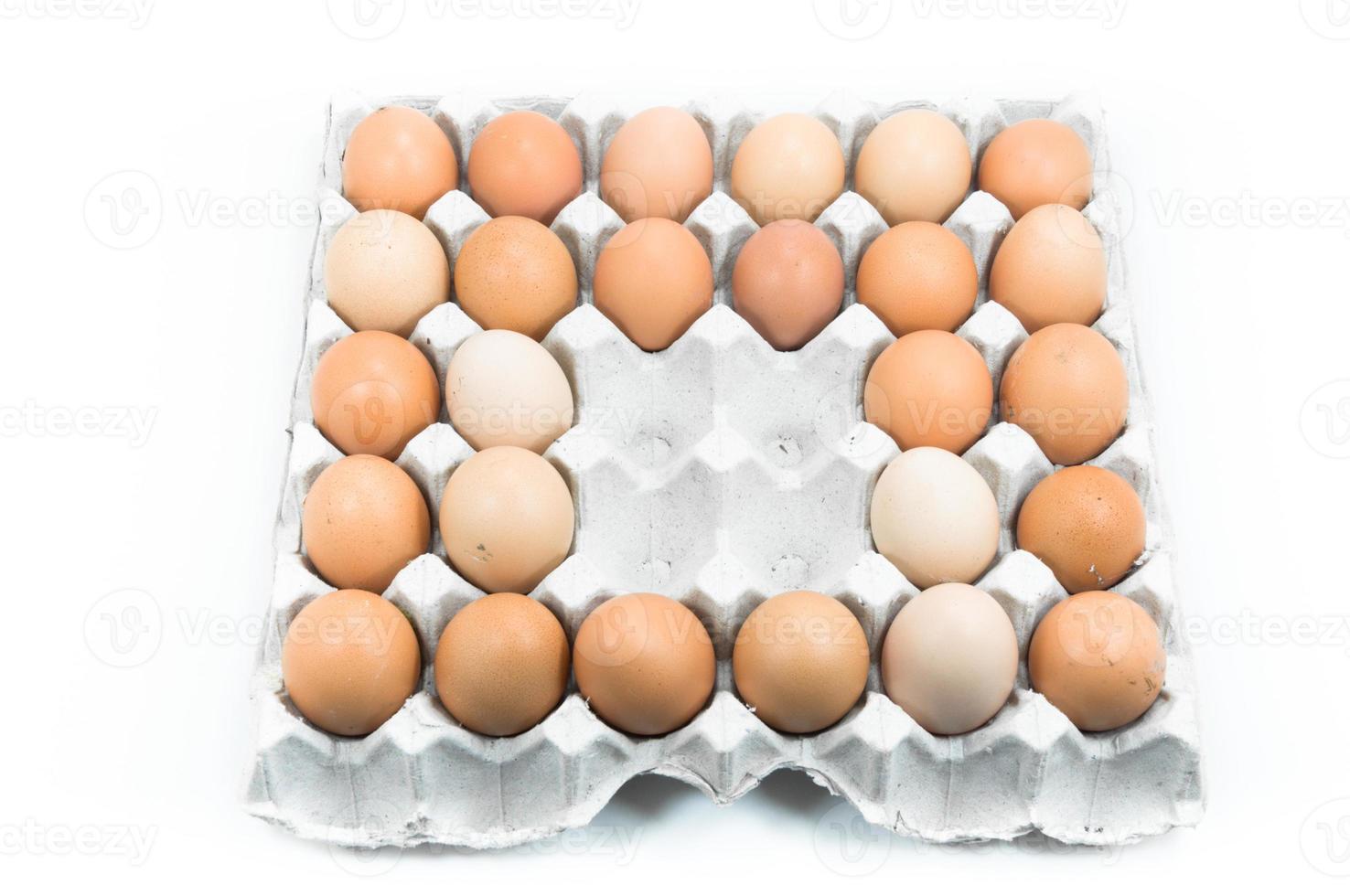 Eggs in paper tray on white background,Brown eggs in an egg carton photo