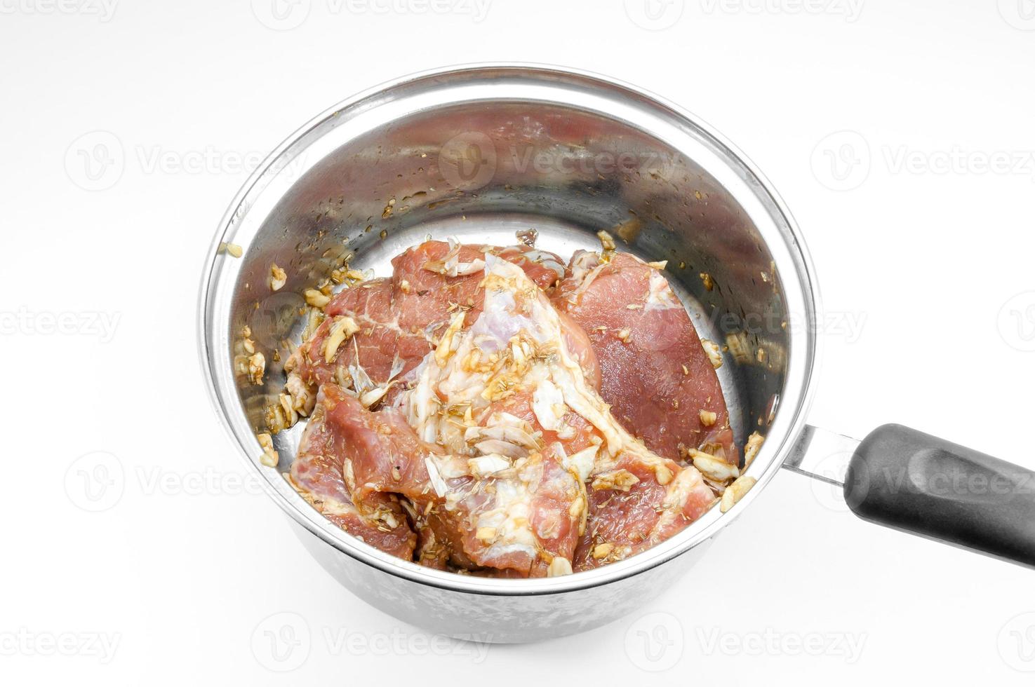 raw steak in frying pan isolated on white background photo