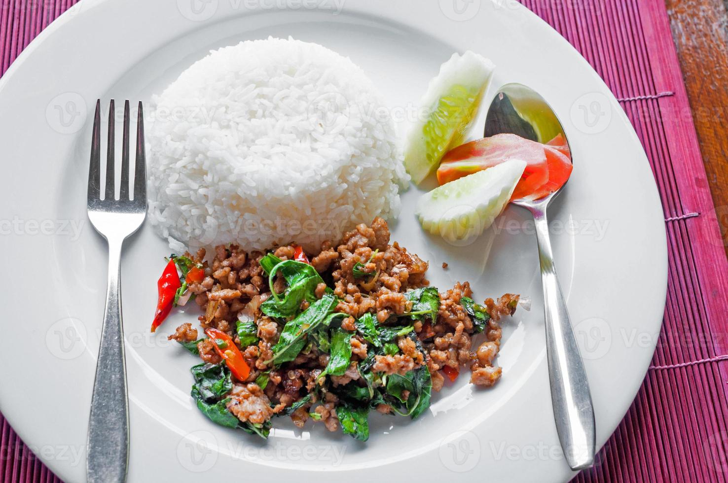 Thai stir-fried pork and basil served with rice photo