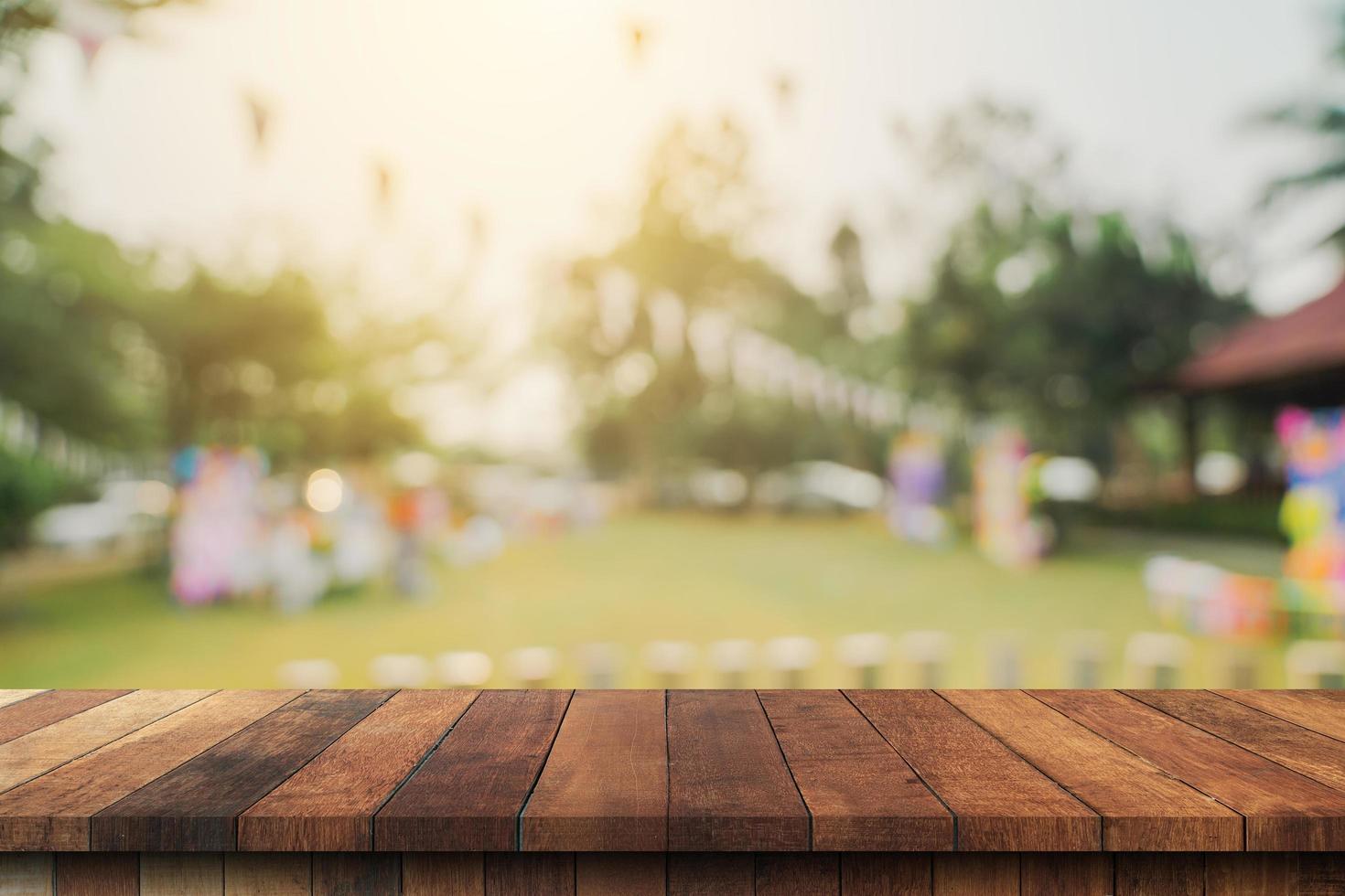 Empty wooden table top and Abstract blurred light bokeh and blur background of garden trees in sunlight. product display template with copy space. photo