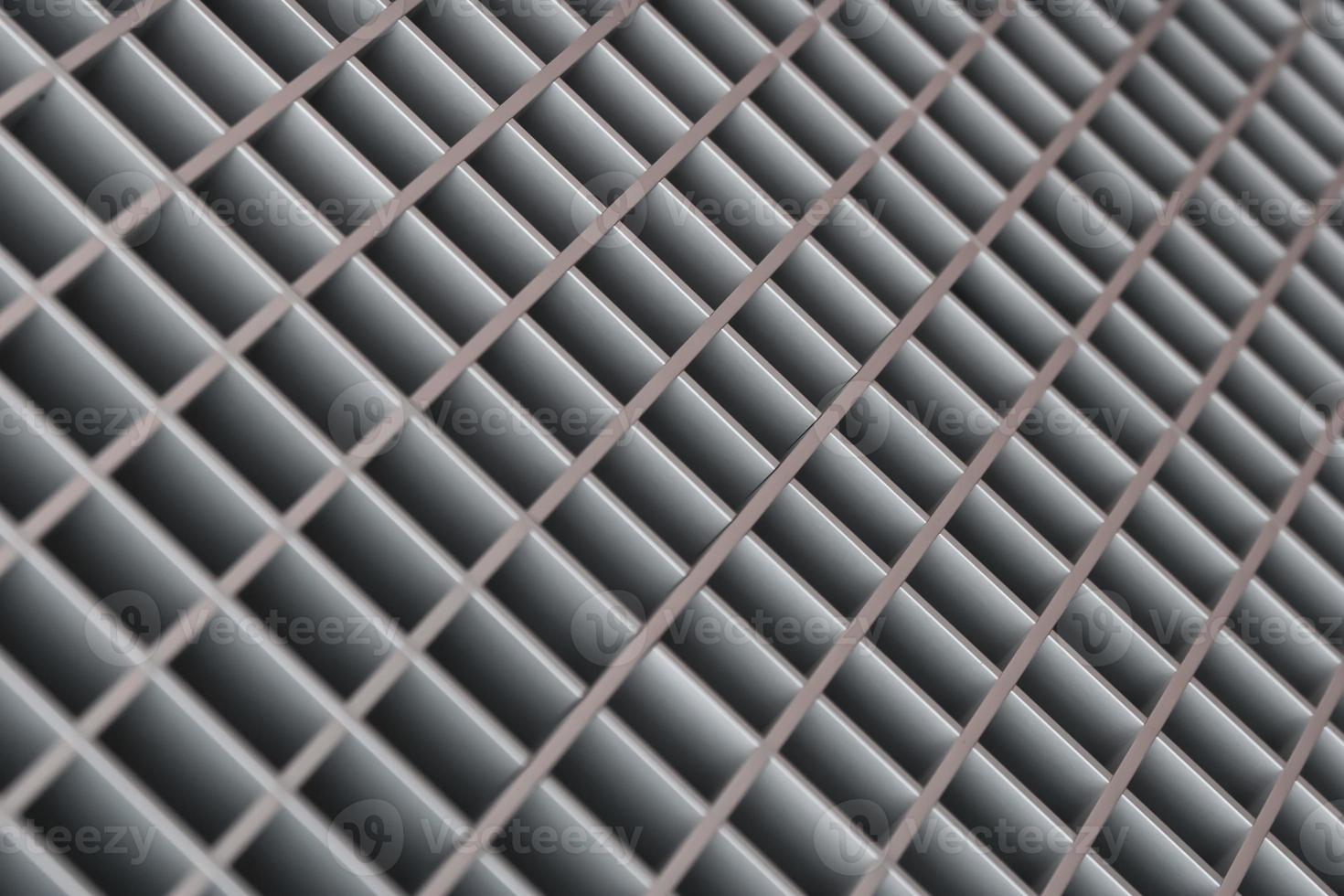 Abstract blurred diagonal lattice background from metal. Gray tint. photo