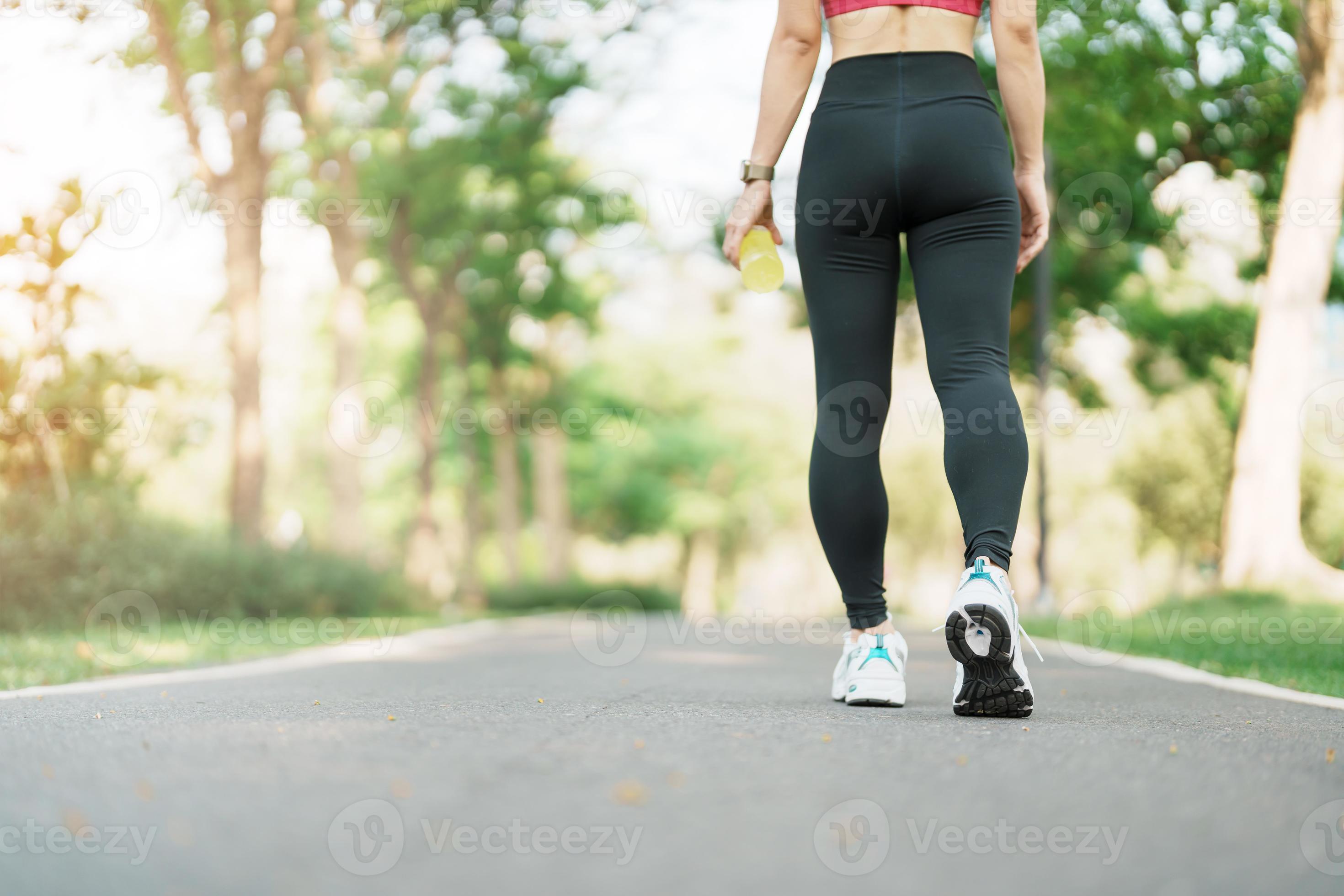 woman jogging and walking on the road at morning, Young adult female in