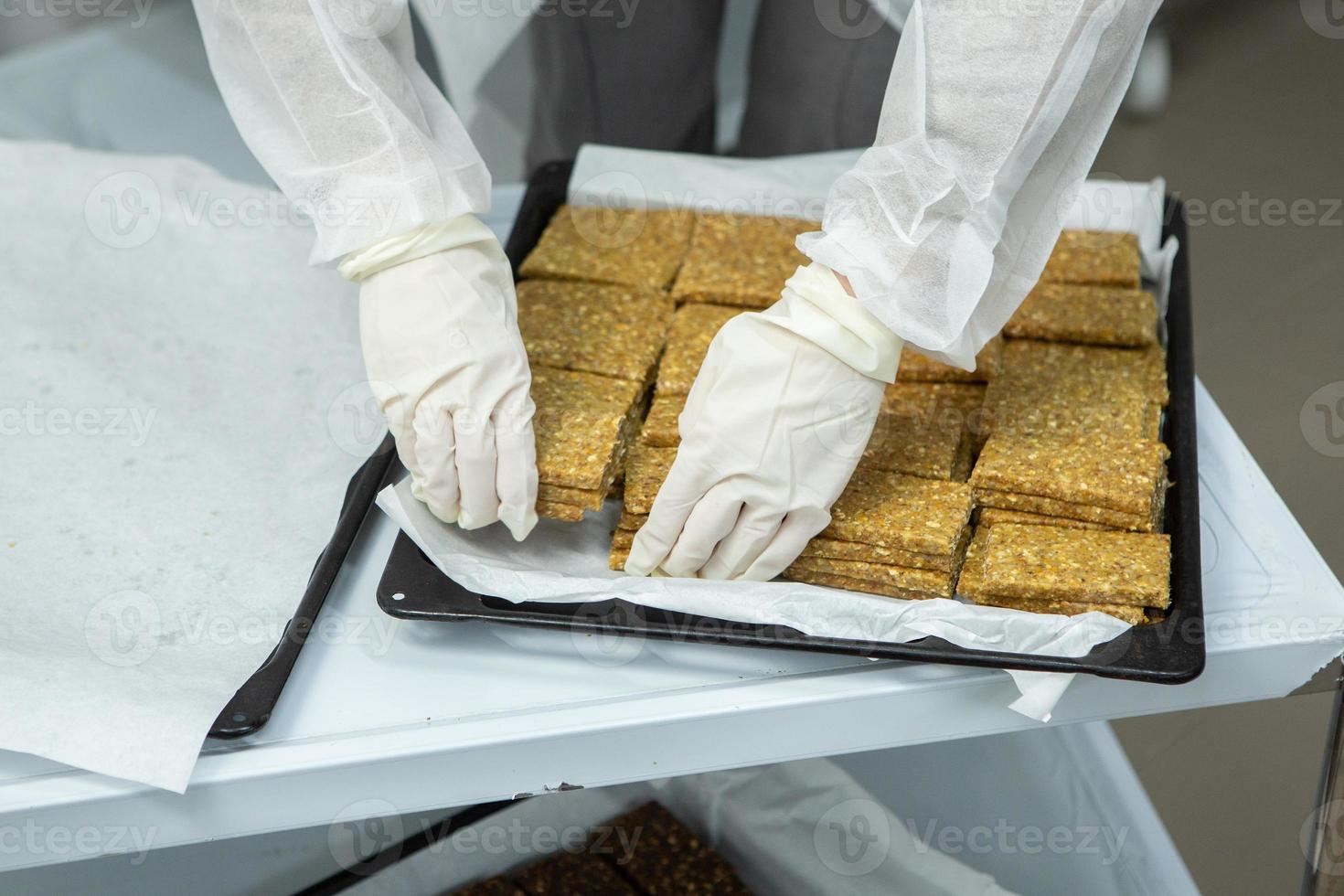 Assortment of cereal or protein bars that leave the assembly line at the factory. Healthy pre or post workout snacks with fruits, nuts and berries. photo
