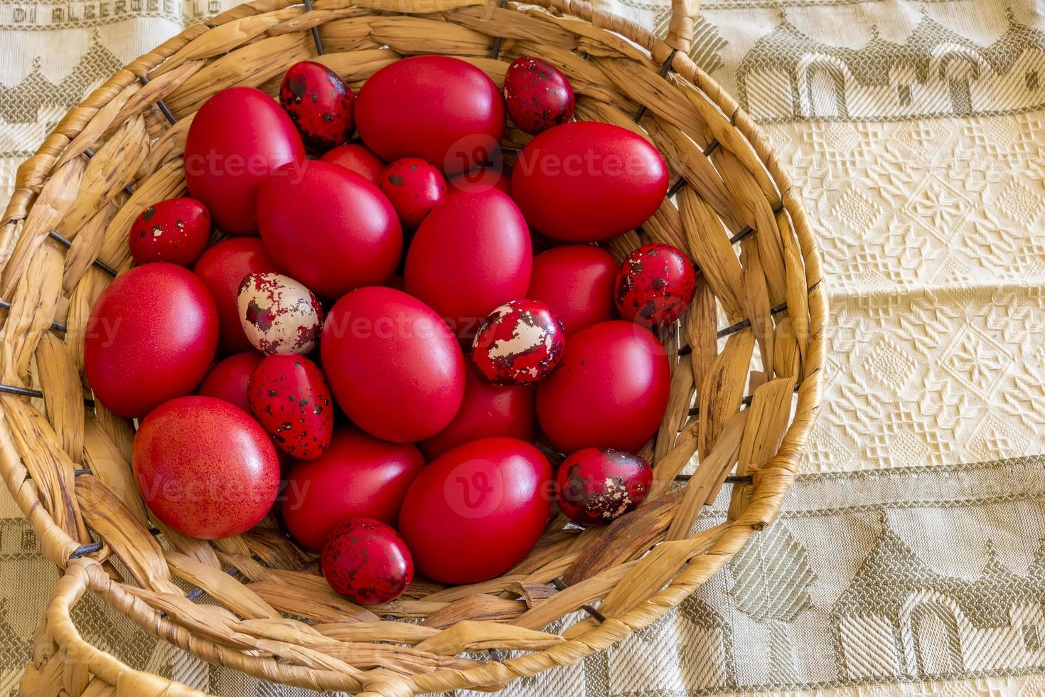 Many Easter red colored eggs in the basket on the table. Top view photo