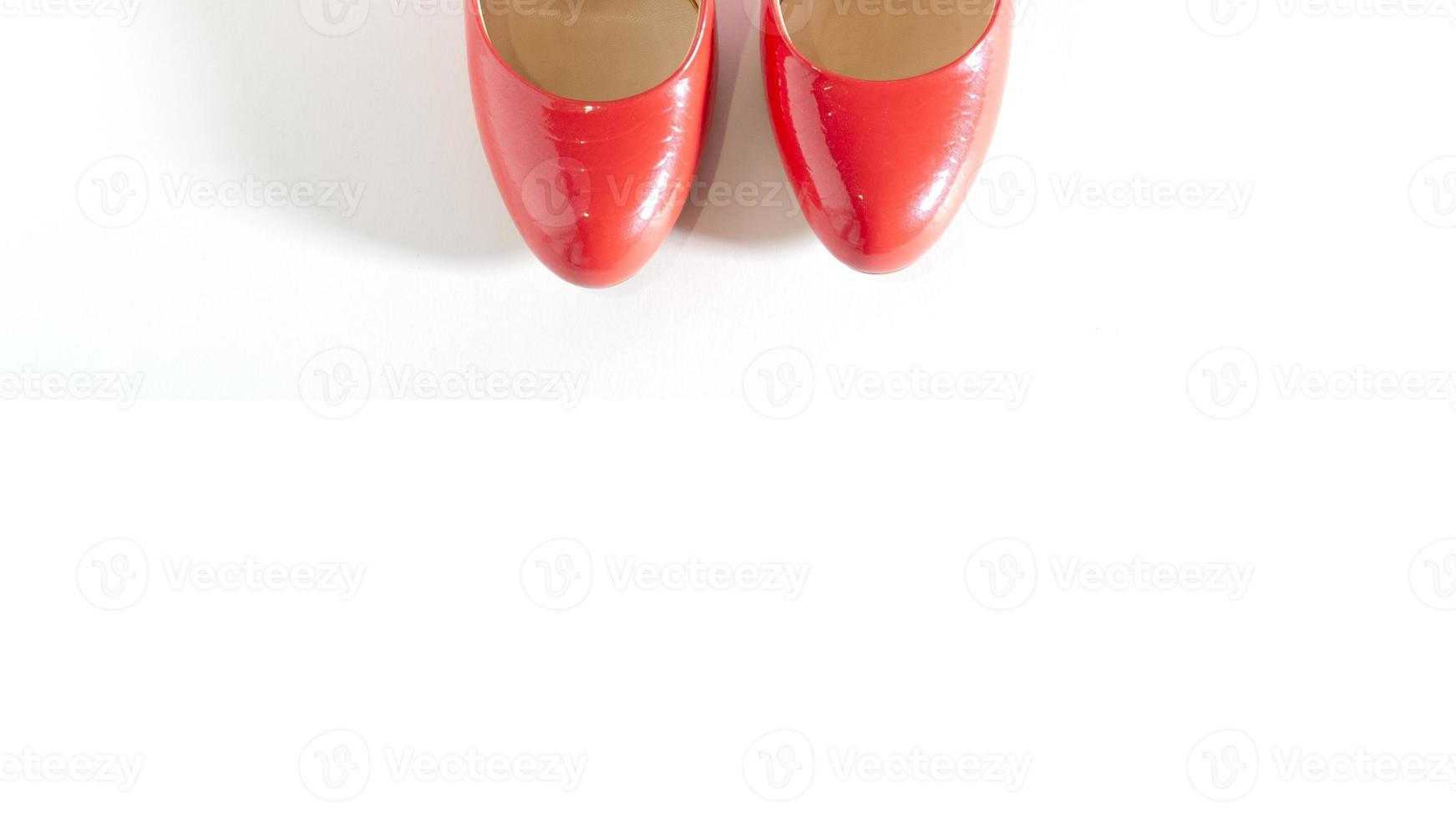 Bright red shoes on the white background. Clipped front view picture. Beautiful high heels shoes. Element for design. Space for text. photo