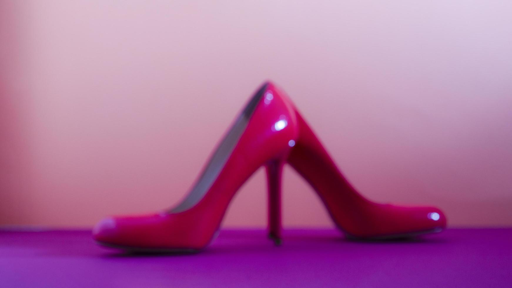 Soft focus blurred picture. Blurred background. Elegant classic shoes close-up. Bright pink high heeled shoes. photo