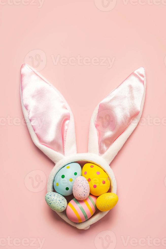 Happy Easter. Colorful easter painted eggs on white bunny ears with copy space for text photo