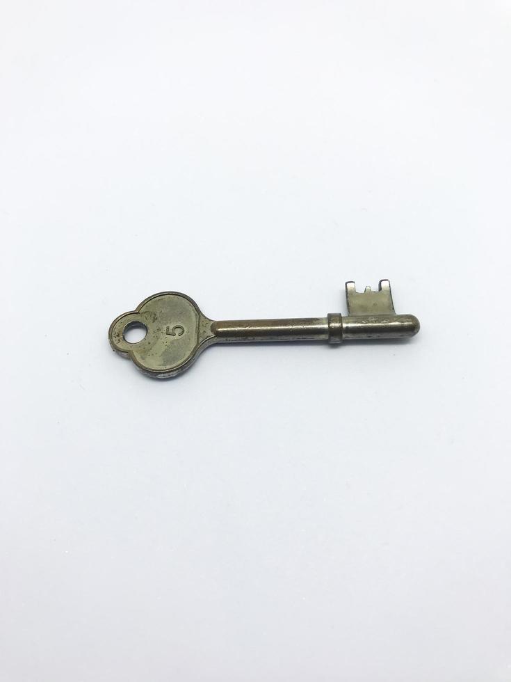 Old key isolated on white background photo