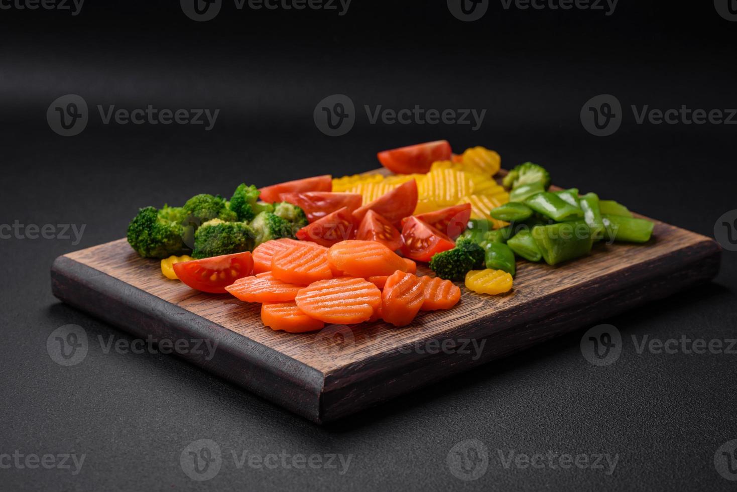 Salad of fresh and steamed vegetables cherry tomatoes, broccoli and carrots photo