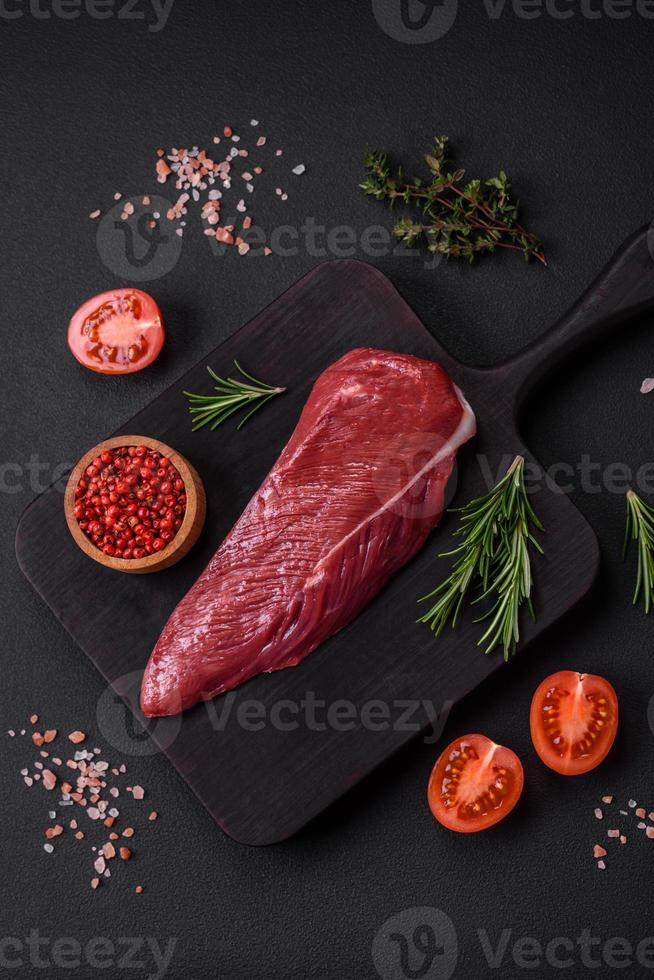 Beautiful fresh piece of raw beef on a wooden cutting board photo