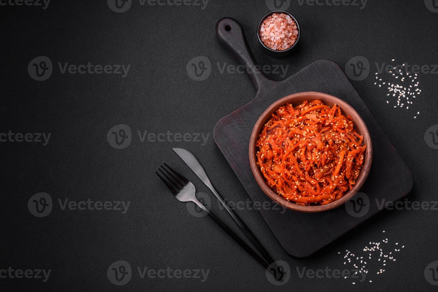 Dried squid chopped into slices and seasoned with sesame seeds and spices photo