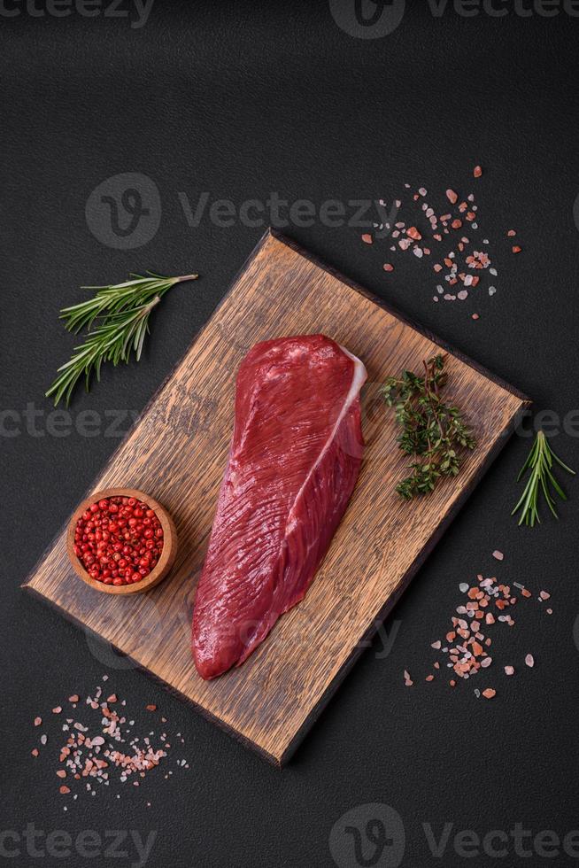 Beautiful fresh piece of raw beef on a wooden cutting board photo