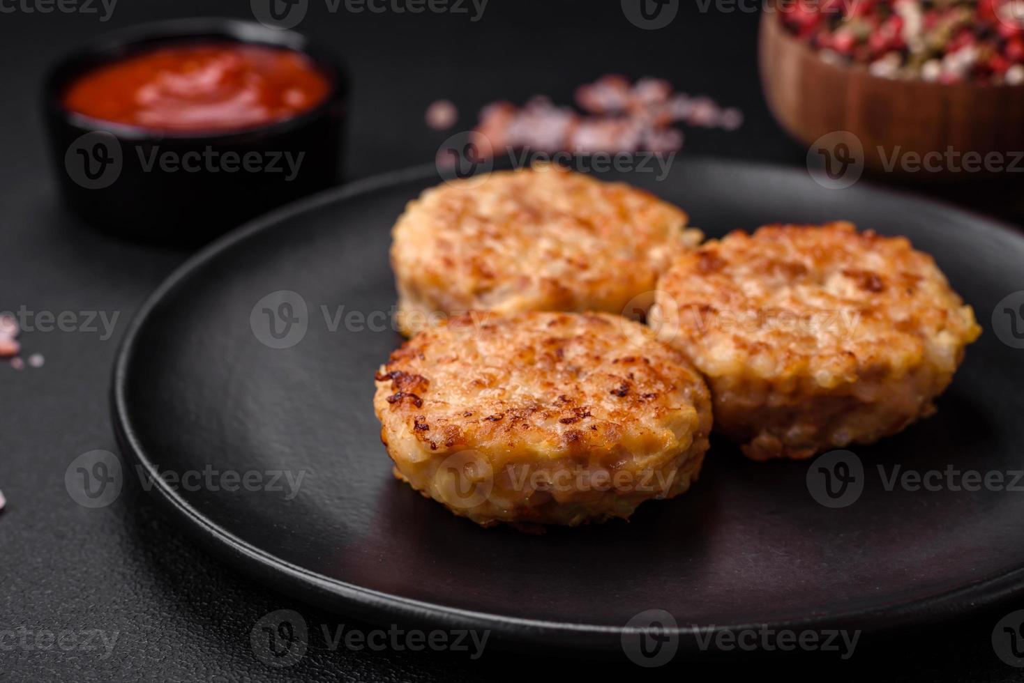 Delicious fresh cutlets or meatballs with spices, herbs and tomato sauce photo