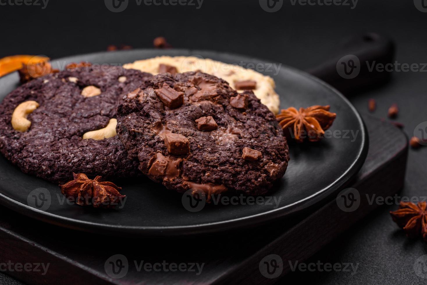 Delicious fresh crispy oatmeal cookies with chocolate and nuts photo