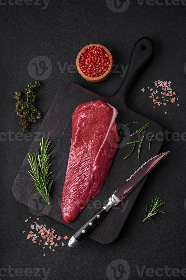 Beautiful fresh piece of raw beef on a wooden cutting board photo