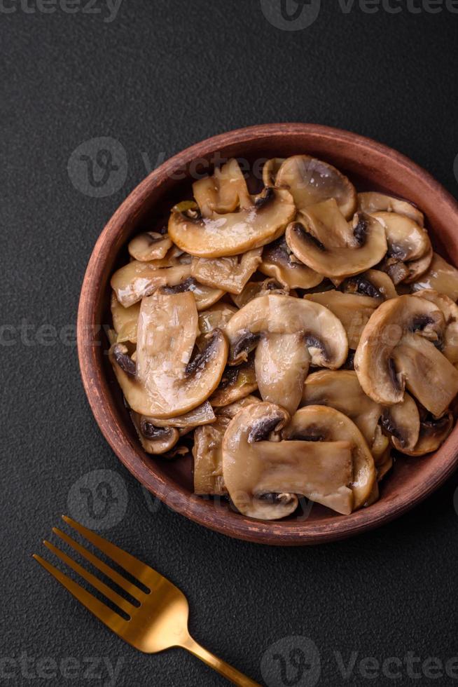 Fried or stewed champignon mushrooms in the form of slices with onions photo
