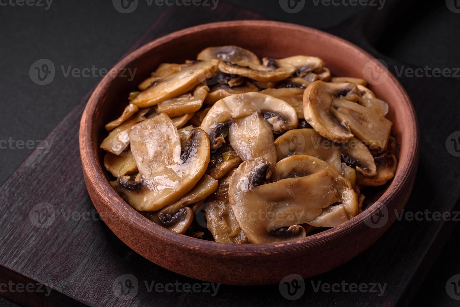 Fried or stewed champignon mushrooms in the form of slices with onions photo