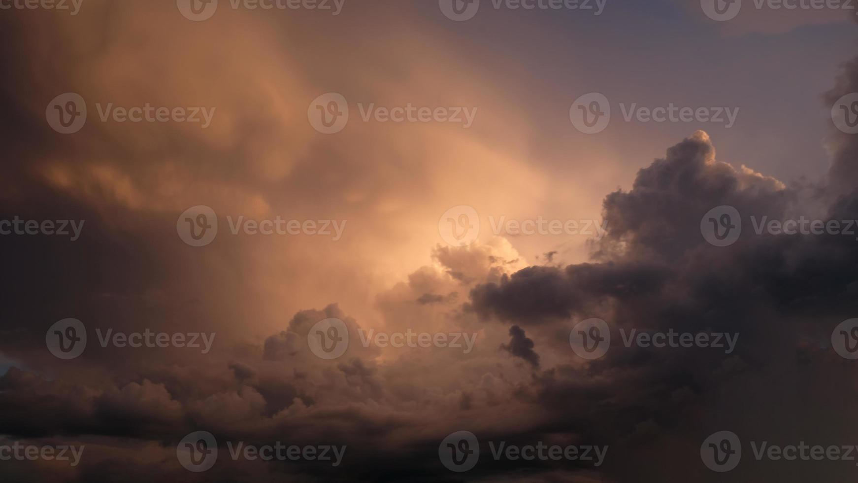 Dramatic sky. Purple and pink sky with clouds of sunset or sunrise background. Purple sky with clouds. Twilight colorful skies. Air and fluffy clouds. photo