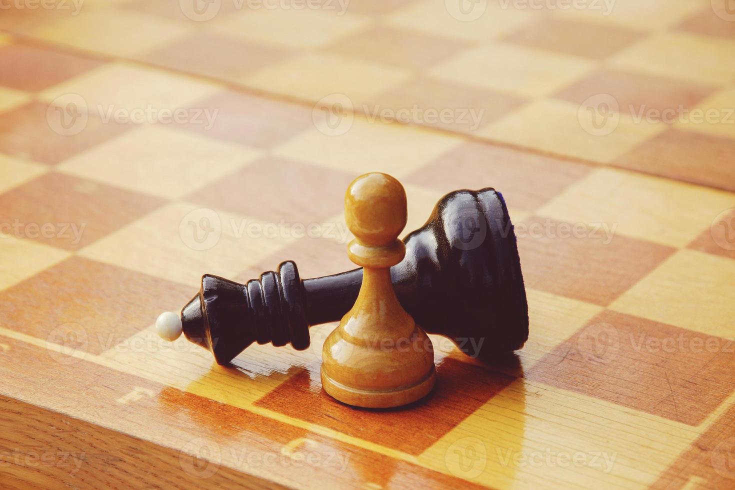 chess game won by white pawn against black king photo