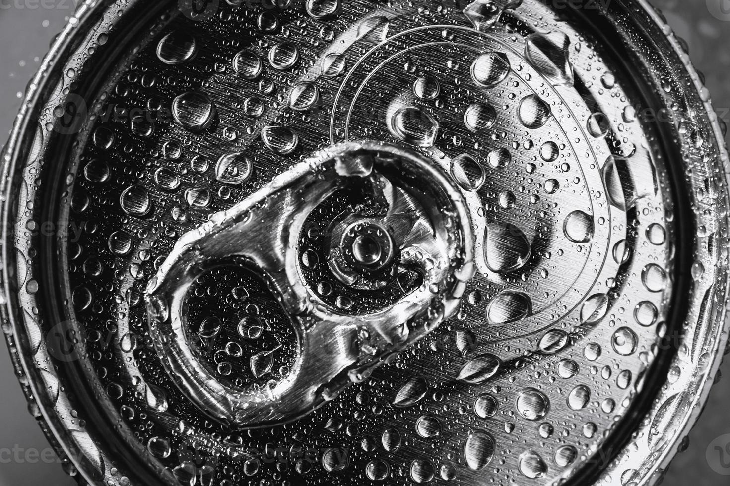 Aluminum soda can top in water drops closeup photo