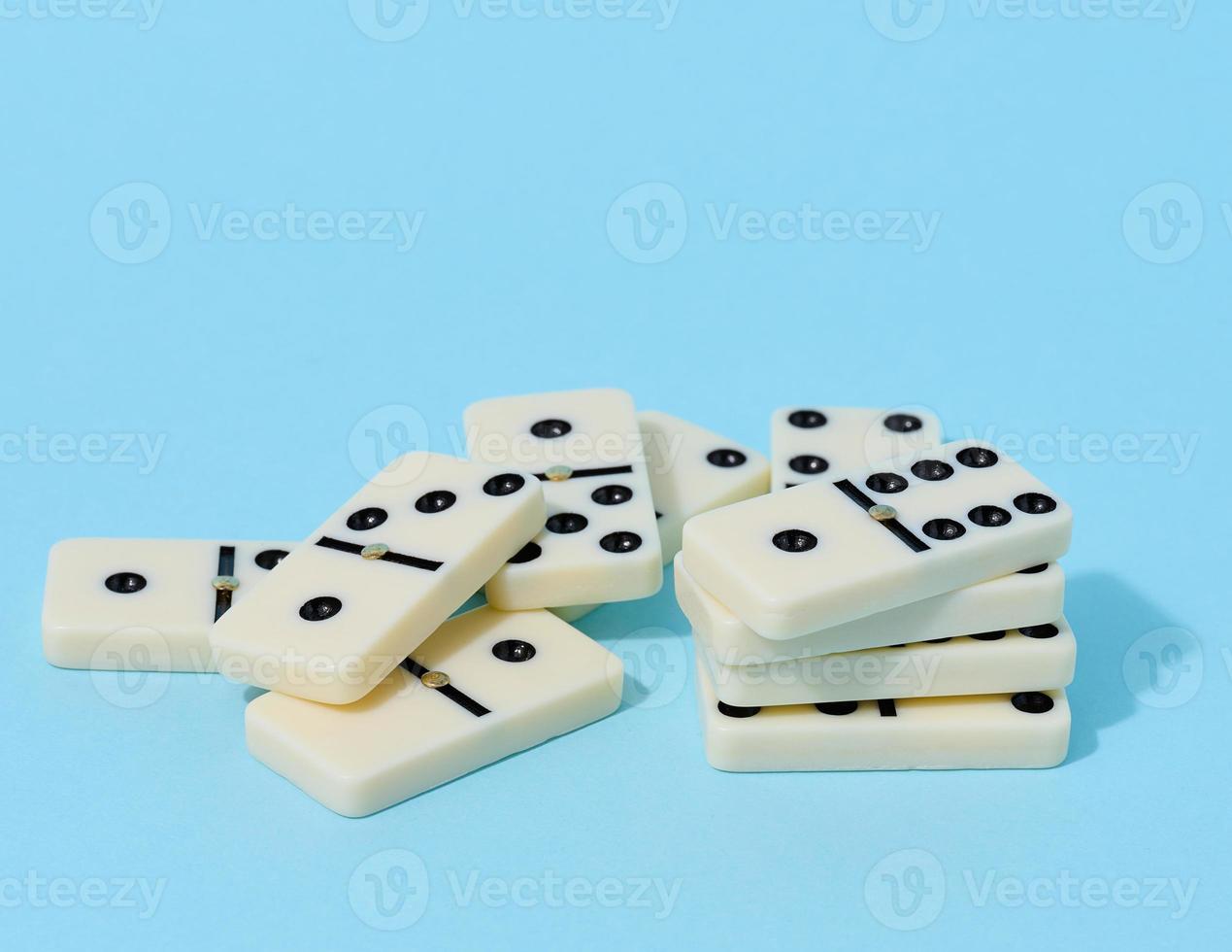 A stack of dominoes on a blue background, an intellectual game photo