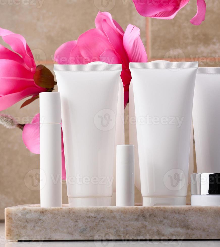 White plastic tube, jar for cosmetics. Container for gel, cream, tonic. Advertising and product promotion photo