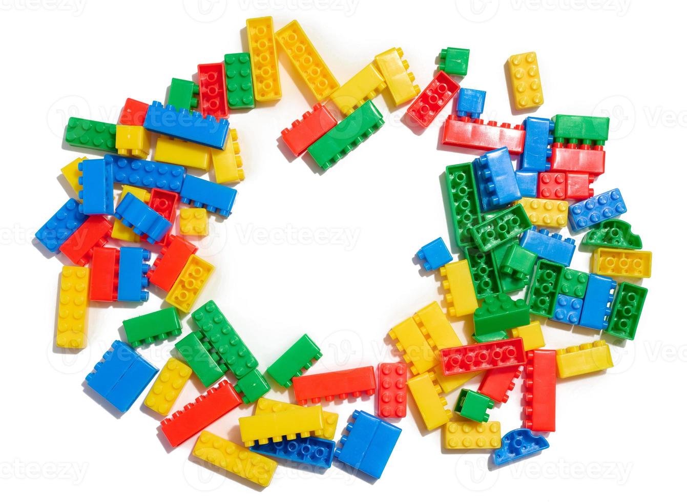 Multi-colored plastic cubes of a children's designer on a white isolated background, top view photo