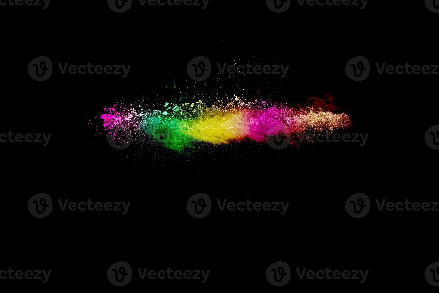 Abstract multi color powder explosion on black background.  Freeze motion of colorful dust  particles splash. Painted Holi. photo