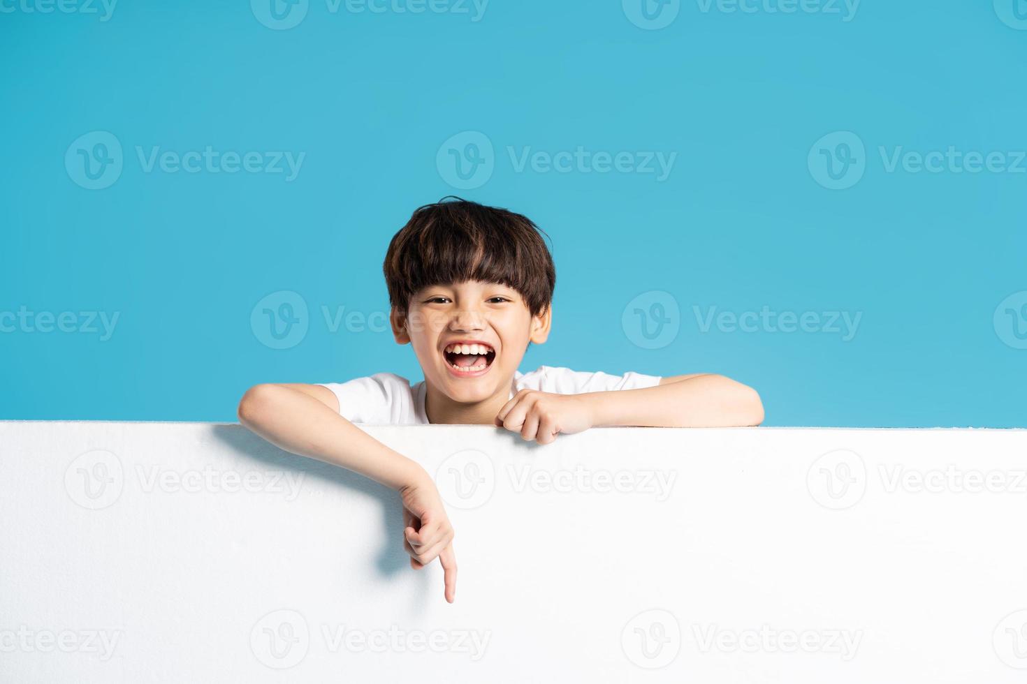 Asian boy portrait on blue background photo