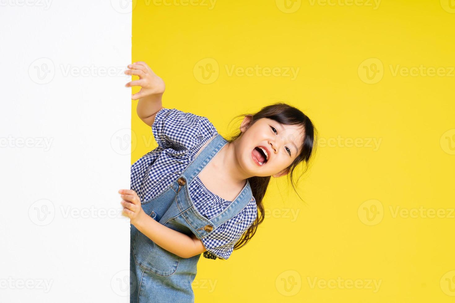 beautiful asian girl portrait, isolated on yellow background photo
