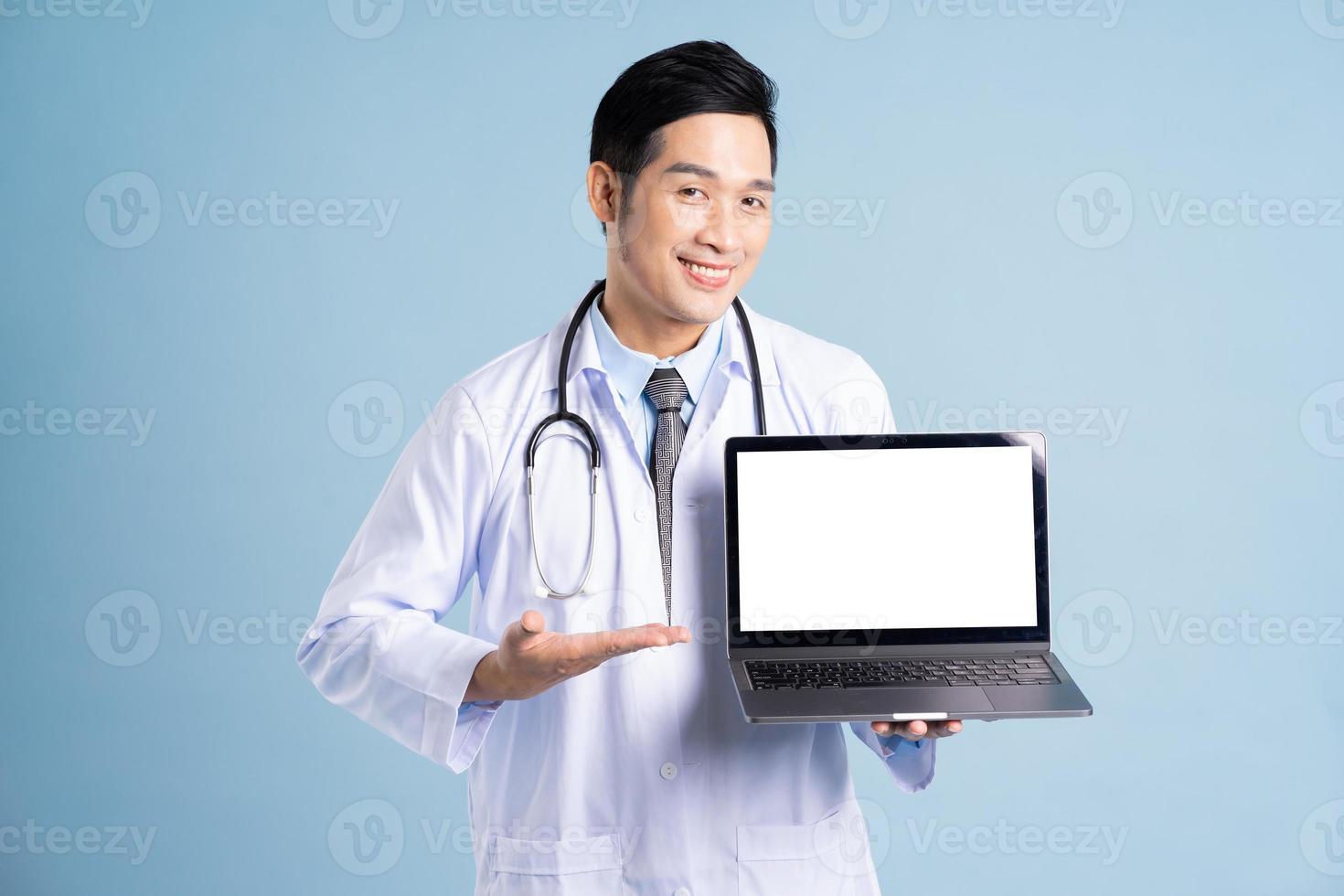 Asian male doctor portrait on blue background photo