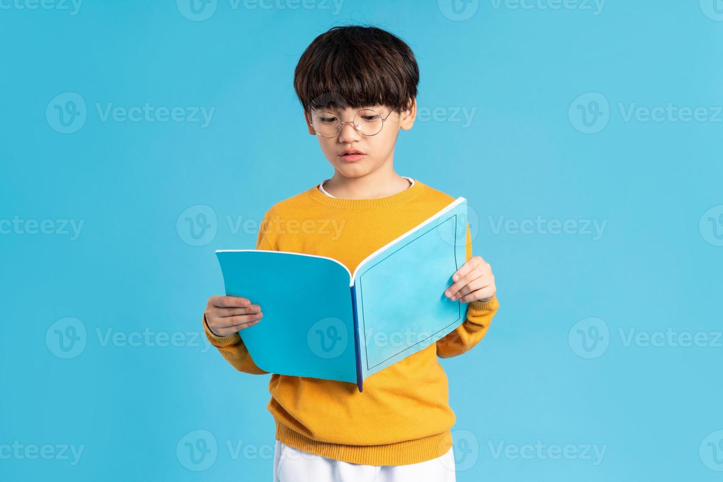 Portrait of Asian school boy born on a blue background photo