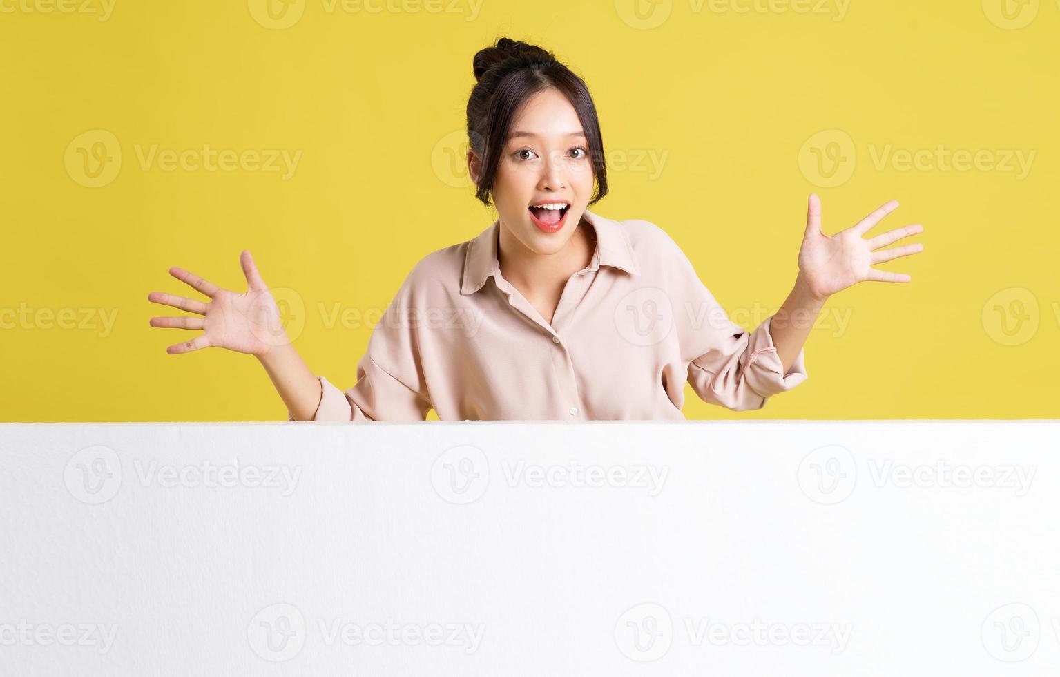 image of asian girl standing and posing with billboard photo